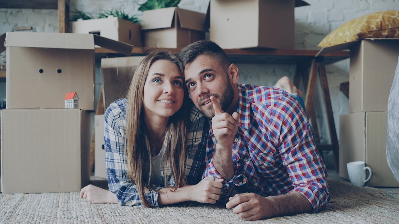 Happy couple planning their future in a new home. Moving concept.