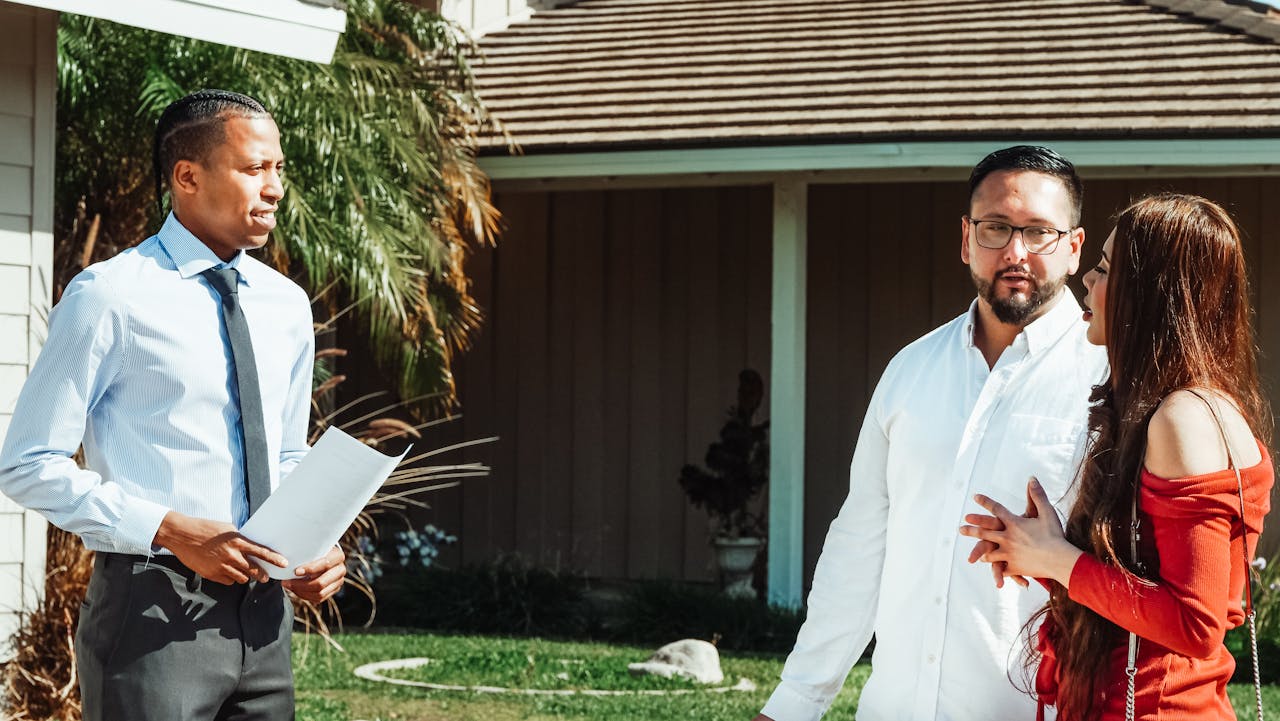 The Art of Drawing Readers In: Your attractive post title goes here A real estate agent showing a house to a couple, discussing options.