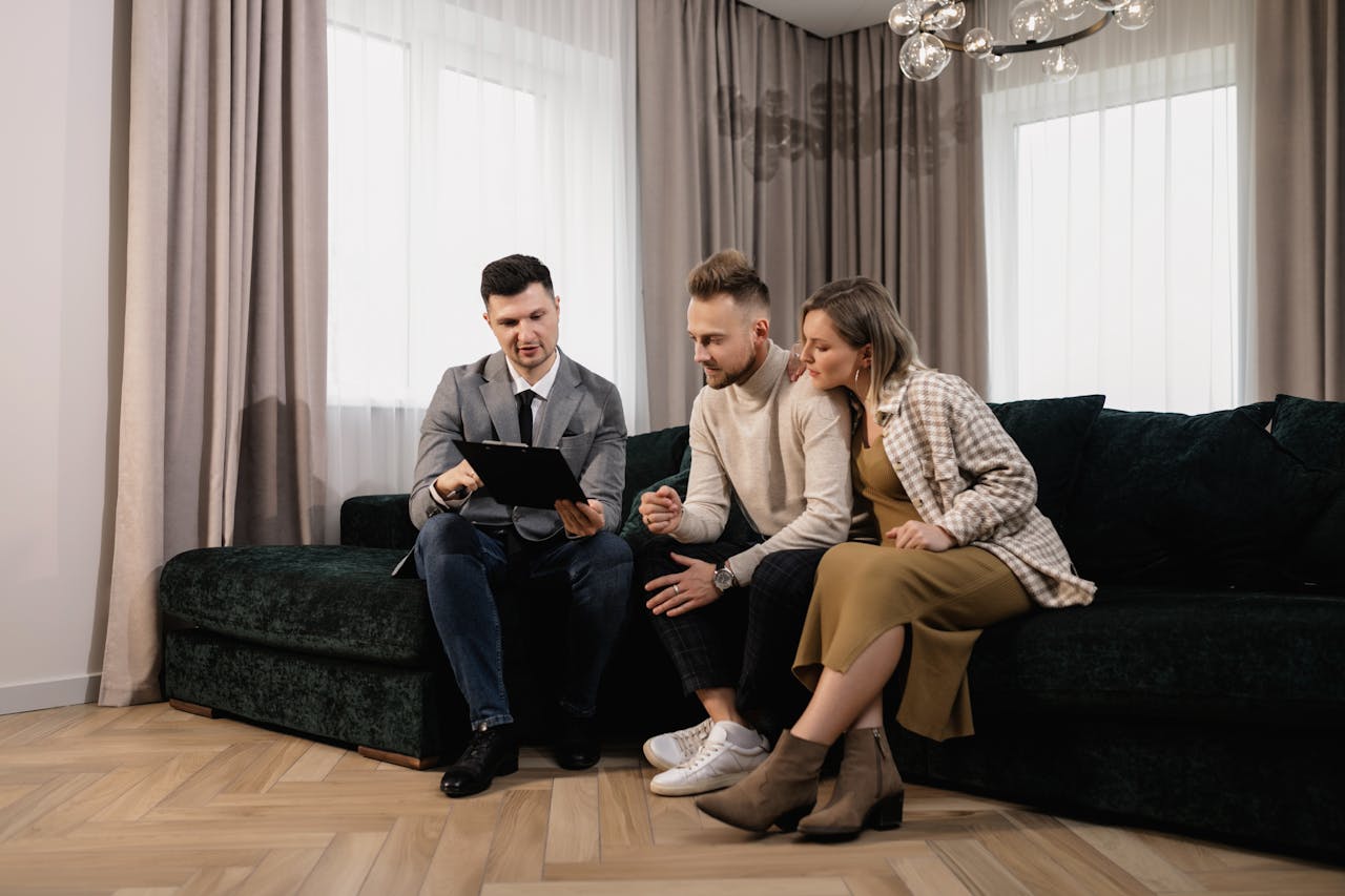 Crafting Captivating Headlines: Your awesome post title goes here A real estate agent shows a property listing to a couple in a modern living room.